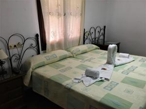 a bedroom with a bed with two towels on it at La Despensa del Valle in Restábal
