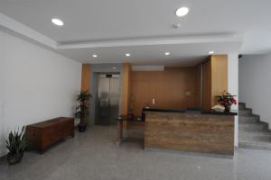 an office lobby with a reception desk and stairs at Senhor dos Perdoes Alojamento Local in Ribeirão