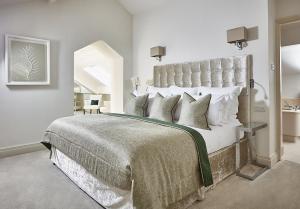 a bedroom with a large bed with a large headboard at The Samling Hotel in Windermere