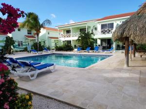 a swimming pool with lounge chairs and a resort at Alifra Apartment in Lagun