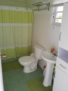 a bathroom with a toilet and a sink at Alifra Apartment in Lagun