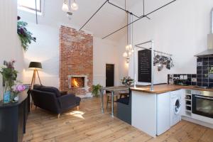 a living room with a table and a fireplace at Two Bare Feet in Winchester