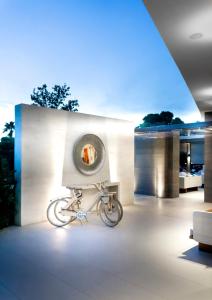 a bike parked in front of a building with a window at Somewhere Vouliagmeni in Athens