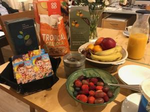 a table with a bowl of fruit and a bowl of cereal at Balmillig B&B in Helensburgh
