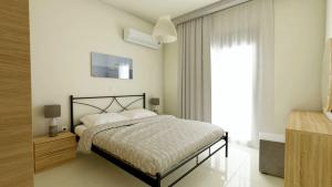 a bedroom with a bed and a large window at luxury - comfy center rodos in Asgourou +18 photos