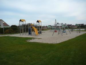 a park with a playground with a slide at Strandslag Zanddijk 229 Julianadorp aan Zee in Julianadorp