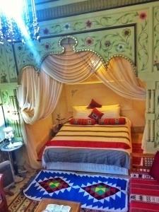 a bedroom with a bed with a canopy at Dar Baaziz in Sousse