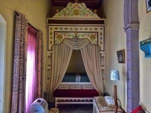 a bedroom with a bed with a canopy at Dar Baaziz in Sousse