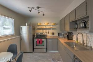 a kitchen with a stainless steel refrigerator and a sink at 2BR Garden-level Great Outdoors Dog Friendly in Colorado Springs