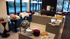 a restaurant with plates of food on a table at Hotel Burgblick in Hochburg-Ach