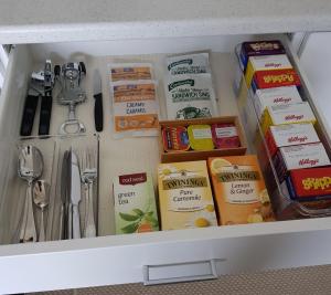 a drawer filled with food and utensils at Botanical Haven BnB in Tauranga