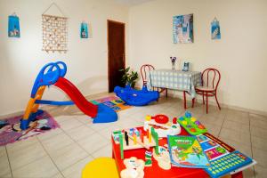 a childs play room with a table and play equipment at Pyrgadikia Paradise in Pyrgadikia