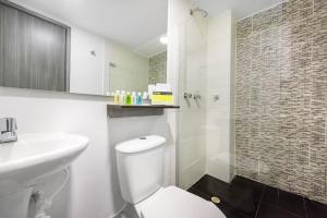 a bathroom with a toilet and a sink and a shower at Ayenda 1024 Agora Inn Hotel in Bogotá +21 photos