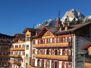 a group of buildings in front of a mountain at Dolomiti Skyview in Carbonin +10 photos