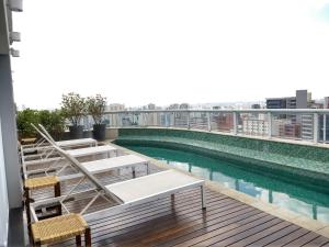 a swimming pool on the roof of a building at Apartamentos Juliana Bela Vista in Sao Paulo