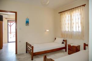 Postel nebo postele na pokoji v ubytování Pyrgadikia Paradise