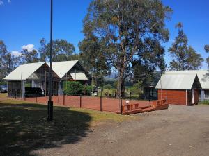 a tennis court in front of a building at Vineyard Hill in Lovedale