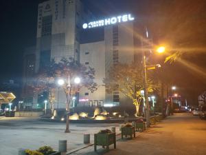 a city street at night with a star hotel at New Grand Hotel in Daegu +1 photo