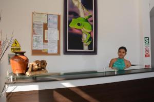 a boy in a glass counter in a room at Hostal Casa Blanca in Tarapoto