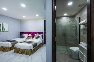 a hotel room with two beds and a shower at V Boutique Hotel in Phnom Penh +53 photos