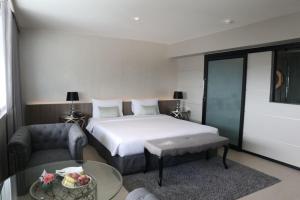 Postel nebo postele na pokoji v ubytování Pearl Hotel Phuket