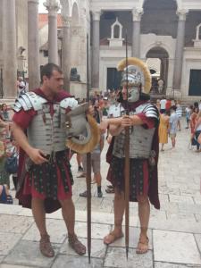 two men in historical costumes standing in front of a crowd at Zdenka Studio Split in Split