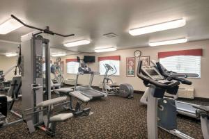 a gym with treadmills and ellipticals in a room at Travelodge by Wyndham Missouri Valley in Missouri Valley