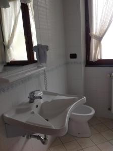 a bathroom with a sink and a toilet at Monte Degli Ulivi Country House in Mercato San Severino