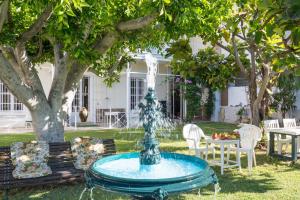 a fountain in the yard of a house at Villa Amalia Suites Malaga in Málaga