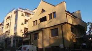 a white van parked in front of a building at Нощувки Ботеви in Shumen