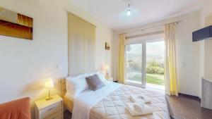 Posteľ alebo postele v izbe v ubytovaní Meliades Villas