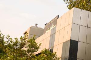 a building with a sign on the side of it at Hotel Mumbai International- Near T2 International Airport in Mumbai