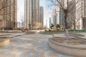 a park in a city with tall buildings at Tianjin Nankai·Nanshi Food Street· Locals Apartment 00136410 in Tianjin