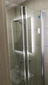 a shower with a glass door in a bathroom at Comfortable Studio only 20 minutes from International Conference Center Katowice best place for WUF2022 EEC TNF OFF etc in Siemianowice Śląskie