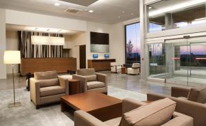 a lobby with couches and chairs and a table at Novotel Toronto Vaughan Centre in Vaughan