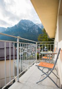 a chair on a balcony with a view of a mountain at Vila Alegria in Buşteni
