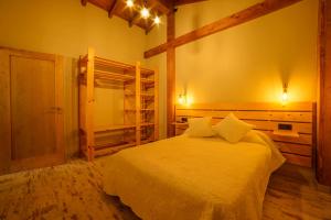 a bedroom with a bed in a room with a bunk bed at Rincón de Sira in Cee