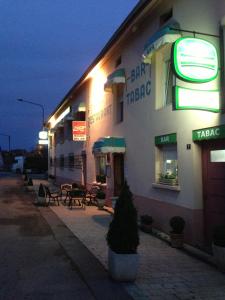 a building with neon signs on the side of it at Bel Air in Marville +17 photos