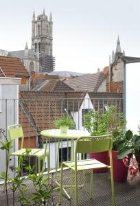 a patio with a table and chairs on a balcony at Loftsuite in Ghent