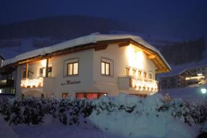 a building with lights on in the snow at night at Apart Montana in Nauders