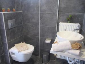 a bathroom with a white toilet and a sink at Selene's House in Skala Kallirachis +27 photos