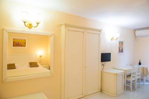 a bedroom with a mirror and a bed and a table at Hotel Seggio in Vieste