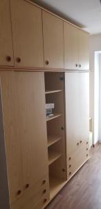 a closet with wooden cabinets and shelves in a room at Casa vacanze in Trentino. Altopiano di Lavarone in Lavarone