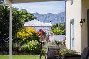 a view of a yard with mountains in the background at Lavender Cottage in Franschhoek