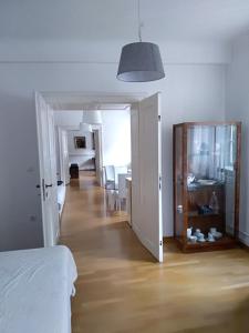 a bedroom with a bed and a room with a hallway at SIPPO Apartments in Ljubljana