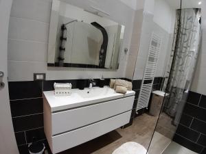 a bathroom with a white sink and a mirror at ALESSANDRA'S HOME in Verona