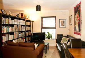 a living room with a book shelf filled with books at Kieran's Place in Dublin