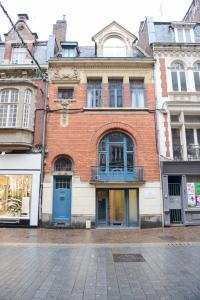 a brick building with blue doors on a street at Lille Avenue in Lille