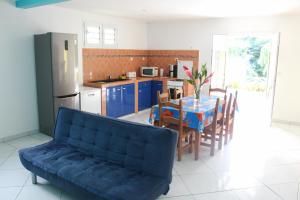 uma sala de estar com um sofá, uma mesa e uma cozinha em Villa Hausseman em Rivière-Pilote