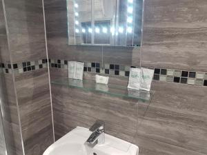 La salle de bains est pourvue d'un lavabo et d'un miroir. dans l'établissement The Glebe Hotel, à Liverpool